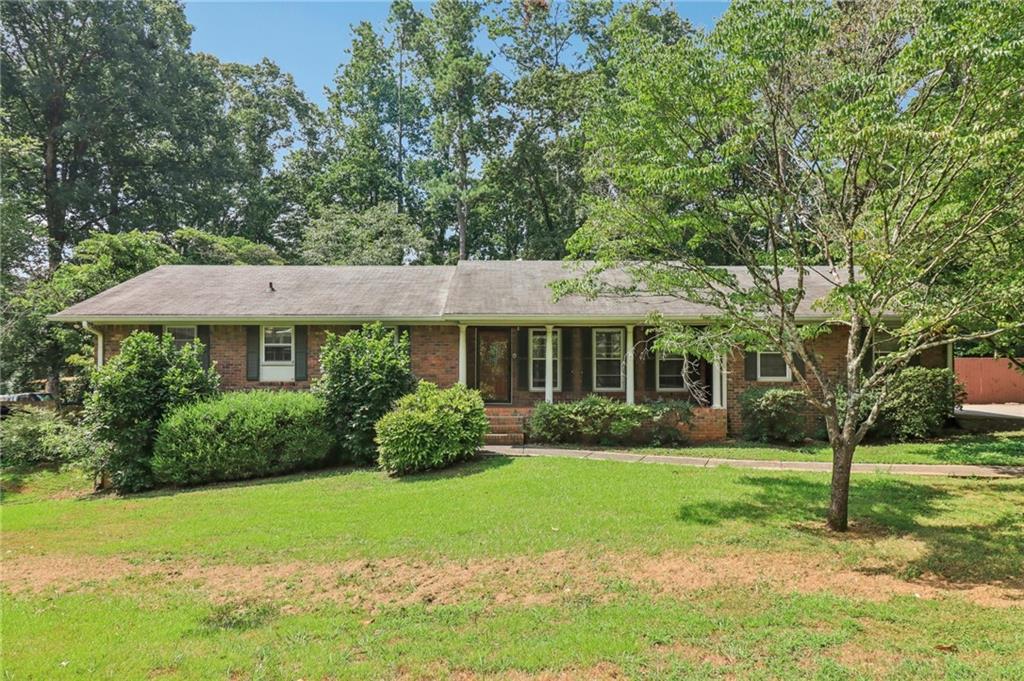 Welcome home to this fantastic 3 bedroom 2 bath, all brick Ranch in established Austell neighborhood, conveniently located near East-West connector! Home features a large formal living room, separate den with masonry fireplace, an eat in kitchen, separate laundry room, covered 2 car carport and a spacious deck outside, overlooking level backyard. Home has New roof, New HVAC system, New Plumbing and sits on a full, unfinished basement ready for quick expansion. Home is being Sold “As-Is” but just a few simple updates will easily make it a showplace. Call to schedule your tour today!