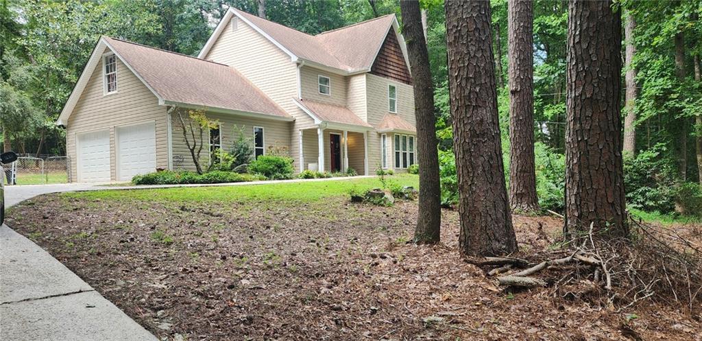 Discover this charming two-story home featuring three spacious bedrooms and 2.5 bathrooms, with an optional fourth bedroom or bonus room perfect for your needs. Nestled on a wooded, private, sloping lot, all rooms and full baths are conveniently located upstairs, offering privacy and comfort. Ideally situated close to downtown Fayetteville, this residence combines tranquility with accessibility, making it an ideal place to call home.
