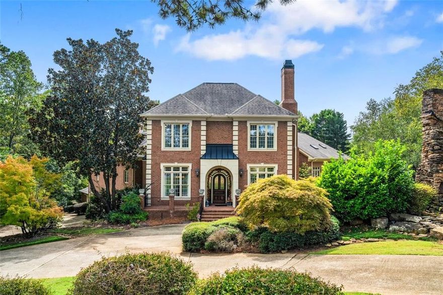 Welcome to this meticulously maintained full-brick estate, gracefully situated on 1.25 private acres in the highly desirable East Cobb area.With 5 bedrooms, 8 baths, and approximately 8,637 square feet of refined living space, this residence offers a rare blend of luxury, comfort, and gracious design.
From the moment you arrive via the circular drive, you’ll be greeted by lush landscaping, ambient outdoor lighting, a serene pond, and a historic 150-year-old chimney that gives character to the front façade. The property includes a five-car finished garage (one bay is used as a workshop with front and rear access), plus lower lot space capable of accommodating up to 20 vehicles—perfect for entertaining or hosting gatherings.
Grand, 11- foot ceilings in the foyer lead you into a world of architectural elegance. The family room boasts soaring 21-foot ceilings and an ornate fireplace, while the formal living and dining rooms feature complementary tray ceilings and a second fireplace. A paneled study offers quiet retreat, and a nearby space to serve as a secondary office or sitting room adjacent to the primary suite.
Designed with both function and style in mind, the kitchen is outfitted with double ovens, a 5-burner gas cooktop with downdraft vent, Sub-Zero refrigerator, dual dishwashers, warming drawers, trash compactor, expansive pantry, and even a dumbwaiter for ease from garage to kitchen. The adjoining keeping room and breakfast area (with its own fireplace) complete this heart-of-home space.
Two master suites grace the main level. The primary suite features dual closets, a spa-style en suite with jetted tub and large shower, private screened porch, a sitting room, and it’s own laundry! The second primary includes a generous walk-in closet and en suite bath.
Upstairs awaits a generous open loft with built-ins, two additional bedrooms, and two full baths. The daylight basement is an entertainer’s dream—complete with spacious living/entertainment rooms, a bar/kitchenette, exercise area, pool table space, an additional bedroom with sitting area, and two full baths. High ceilings, a double-sided fireplace, and dual staircases (front and rear access) enhance the flow. 
Outdoor Living & Amenities
The outdoor spaces are thoughtfully designed for both entertaining and relaxation. Retractable screens and awnings extend living space seamlessly from indoor to outdoor. A large deck with Ipe flooring, terrace-level screened porch, multiple stairs to lower levels, and ambient lighting create an inviting outdoor environment. The grounds are supported by an irrigation system fed by a well, and additional features include a full-house central vacuum, dual 50-gallon water heaters with circulation, a security system, controlled lighting, attic access via retractable stairs, and ceiling fans in all key rooms. This remarkable estate offers the perfect balance of sophistication, comfort, and functionality. Schedule your private tour today and experience this extraordinary property for yourself. Offered by Trailside Equities, an experienced builder and home construction company, this home provides buyers with the chance to create a residence that truly reflects their personal style and preferences at a great price.  The property is available for purchase now, and following closing, our team will work with you to renovate and customize the home to your specifications if it is not perfect for you as-is.  Whatever you envision for this luxury property, Trailside Equities has the expertise to bring your vision to life.