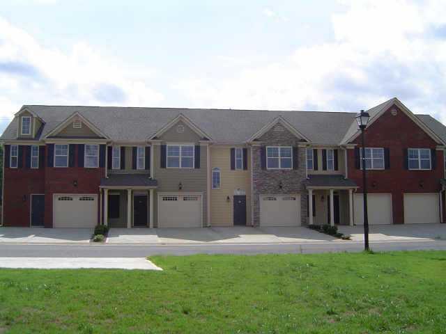 New Townhome with lots of extras! Solid surface countertops, tile and hardwood flooring, upgraded cabinets, gated community. Spacious floor plan with large living area.