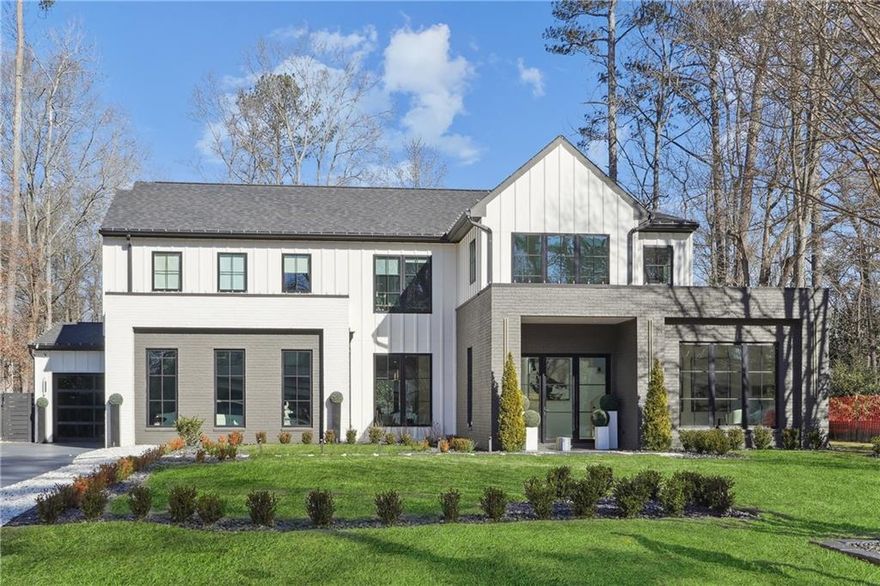 Newer Modern sophisticated home in the sought-after Garden District of Downtown Alpharetta! This 2yr young residence offers a new designer pool, massive spa, and privacy fence, creating a walkout main oasis perfect for entertaining. Customized with top-of-the-line details, the home boasts exquisite landscaping and custom exterior lighting.  Enter into a two-story foyer with wide plank white oak floors, designer lighting, and custom built-ins throughout. Large clad windows fill the home with natural light. The office at the front includes built-ins, while the open dining room, comfortably seating 10-12 guests, features a floor-to-ceiling wine cooler wall and a butler's pantry with a built in Miele espresso machine. The chef's kitchen offers paneled Wolf/Sub-Zero appliances, designer cabinetry, waterfall quartz counters and a walk-in pantry with an abundance of lighted cabinetry. The great room, open to the kitchen, includes a 76" inset TV with a custom surround and electric fireplace, beautiful built-ins and sliding doors. The luxurious main-level primary suite features a stunning feature wall, vaulted ceiling, transom windows, lanai access, a spa-inspired bathroom with an oversized shower, soaking tub, floating vanities, bidet water closet and a custom lighted closet system. Additional main level features include a mudroom with lockers, 3 car granite garage floors, and a laundry room with a sink and cabinetry. The glass railing staircase leads upstairs to four bedrooms. One bedroom, (currently a fashion studio), has vaulted ceilings and transom windows. Two large bedrooms offer walk-in closets and share a spacious double vanity bath.. The in-law/au pair suite offers a vaulted bedroom, a reading nook and a temperature-controlled four-season covered living area overlooking the backyard. The backyard is spectacular, seamlessly flowing from indoor to outdoor spaces. Enjoy a fireside covered lanai with large format tile that continues to the custom pool with a raised spa, black glass tile waterfall, lagoon saltwater PebbleTec pool, and ample patio space for sunning, grilling and entertaining. Wellness upgraded features include a whole home humidifier and water filtration system. Don't miss out on one of the best homes, flattest lots, and neighborhoods in Downtown Alpharetta. Enjoy a lifestyle of easy access to top restaurants, shops, music venues, farmers markets, parks and the Greenway!