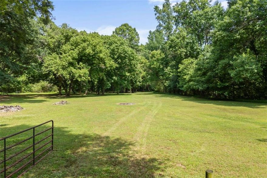 Custom-built home on 6+ acres w/ creek in Loganville school district! This home features a large eat-in kitchen with breakfast room, island, tons of cabinets, and built-in refrigerator. Other features include a huge two-story family room w/ floor-to-ceiling brick fireplace, separate dining room, large laundry w/ built-in cabinetry, oversized owner's suite on the main level, office w/ french doors, 4 bedrooms upstairs with tons of closets and storage space. All of this on an unfinished basement ready for your finishing touch! The home also has a barn with its own driveway (separate from the main house) with three bay doors and a bathroom. Little Haynes Creek runs along the entire length of the right side of the property. Additionally, there is fencing in place!