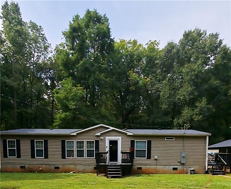 Welcome Home! This home offers plenty opportunities to create your dream landscape with privacy you can't buy in the city and suburbs. You'll be 10 minutes from Georgia State University Newton Campus and from I-20. About 10 minutes outside of Covington, GA this spacious 4 bedroom 2 full baths manufactured home rests on .82 acres located in beautiful historic Newborn, GA. Carpeted bedrooms, Huge walk-in closet, separate tub and shower in Primary bedroom. kitchen with an island. Including a large pavilion for your outdoor gatherings, 2 car-carport with attached storage.
