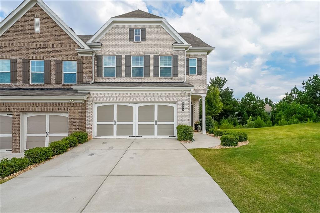 Welcome to Bryton Trace, a charming enclave of just 42 homes conveniently located in Cumming—less than 2 miles from GA 400, The Collection at Forsyth, and Halcyon. With award-winning Forsyth County schools, shopping, and dining just minutes away, this community offers the perfect balance of comfort and convenience. This modern townhome features 4 spacious bedrooms, 3.5 bathrooms, and a versatile flex space that can be used as a home office, playroom, or media room. Inside, the open-concept layout is designed for today’s lifestyle, with a chef’s kitchen that seamlessly overlooks the family room and cozy fireplace. The kitchen shines with natural stone countertops, an oversized island with sink and pull-out trash bin, a large walk-in pantry, breakfast bar seating, and stainless steel appliances including a refrigerator, gas range, and dishwasher. Upstairs, the luxurious owner’s suite provides a relaxing retreat with an oversized walk-in closet, double vanity, garden tub, and separate shower. The convenient second-floor laundry adds ease to everyday living, while additional details such as a mudroom off the two-car garage, a smart lock entry, and other smart home features elevate the home’s modern appeal. Filled with natural light and thoughtful finishes throughout, this move-in ready townhome blends style, function, and location—making it the perfect place to call home.