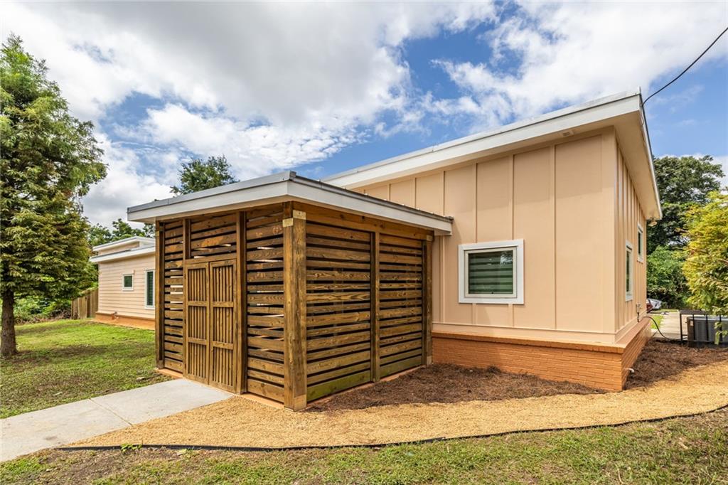 Very nice Commercial live/work space located in the popular Joyland neighborhood! Only .6 mi from the BeltLine, this area is ready to benefit from all the BeltLine has to offer. A +/- 1,677 SF building zoned C1, built in 2019, this property offers a 1BR/1BA living space with a large living/kitchen area plus 2 screened porches - a larger one for dining and lounging off the living/kitchen area, and a smaller, more intimate one off the bedroom (the bedroom, by the way, is spacious enough for a king bed!). A demising wall separates the commercial area which includes a large open work area, a screened area at the front entrance, plus a half-bath. The half bath in the commercial space was designed to be large enough to accommodate adding a shower stall to give the option of 2 separate apartments - a studio and the existing 1 bedroom - with the addition of a small kitchen in what’s currently the commercial space. Some features of the property include a gas cook-top, refrigerator/freezer, dishwasher and a washer/dryer set. There are 2 climate-controlled zones - 1 for each side. The entire back yard is enclosed with a 6 ft privacy fence. Because there is a creek running through the adjacent rear lot, City of Atlanta required the installation of a detention pond, which was installed underground, thus saving the backyard space. There are 5 parking spaces, including 1 HC space. Hurricane strength glass in all the windows and doors, provide additional insulation and protection from the elements! All of the staging tables and bed can remain with the sale or be removed prior to closing as the Buyer wishes.
Hardi-plank siding plus a metal roof make this a very sturdy and attractive location for your Buyer looking for a live/work space.
Property has been completely repainted inside and out, professionally cleaned and is move-in ready. Property is being sold "AS IS-WHERE IS" with the right to inspect.