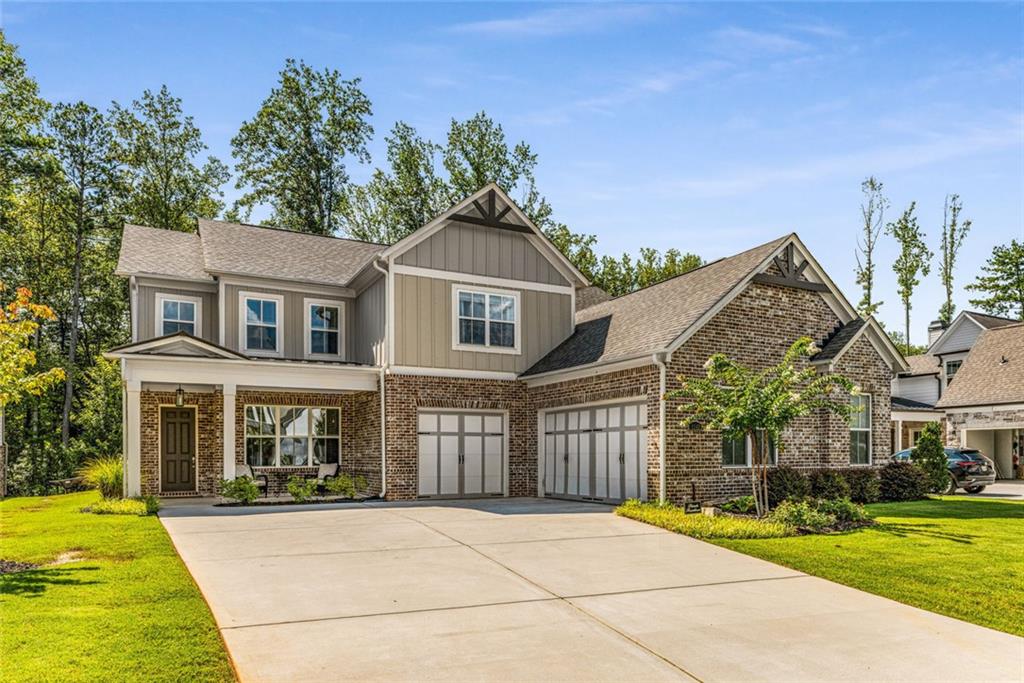 Discover your dream home in tranquil Ward Mills Farm conveniently located near top-rated schools and a quick 7 minute drive from The Avenues at West Cobb. This breathtakingly modern craftsman style home built in 2021 by Peachtree Residential features 4 bedrooms and 4.5 bathrooms with an oversized 3-car garage is situated on a beautiful tree lined lot with plenty of room for a pool. The open concept floor plan is an entertainer's paradise featuring 10ft ceilings, wide plank hardwood floors, an amazing chef's kitchen with Kitchen Aid appliances and a customized walk-in pantry. Step outside from the great room and you will find an amazing covered back patio featuring a fireplace, providing you with the perfect place to unwind after a long day. In addition to the amazing entertaining space, the main level also features the primary suite with a spa like bathroom and large master closet that has been customized with built-ins. There is also an additional bedroom featuring a walk-in closet and ensuite bathroom. The second floor features two additional bedrooms boasting high ceilings, walk-in closets, and ensuite bathrooms. Additionally, there is a large loft space that would make a perfect media room.