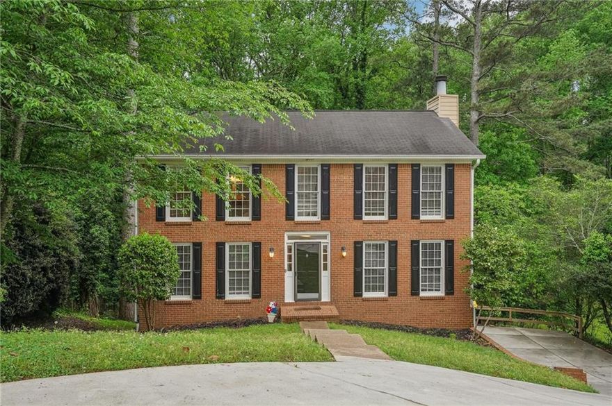 Welcome home to this charming brick front residence nestled in a highly desirable Alpharetta neighborhood! Featuring a welcoming entry foyer, the home opens into a spacious family room with a cozy brick fireplace — perfect for gathering with family and friends. To the left of the foyer, the dining room flows seamlessly into a bright kitchen complete with an island and an eat-in breakfast area. Upstairs, you'll find the spacious primary bedroom featuring dual closets and a primary bath with double vanities and a walk-in shower. Two secondary bedrooms are located on the opposite side of the home, sharing a full bathroom. The partial finished basement offers flexible space ideal for a media room, home gym, or office, complete with a convenient half bath. Step outside to your private backyard oasis, which backs up to serene woods — perfect for relaxing or entertaining on the spacious deck during cool summer evenings. Located within top-rated school districts and offering easy access to shopping, dining, parks, highways, and more, this home combines comfort with convenience. The owner is motivated to sell — let’s get you settled in before the summer holidays! Schedule your showing today and make this wonderful home yours!