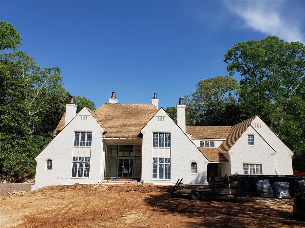 NEW CONSTRUCTION on exceptionally RARE & FLAT 2.3 acre estate with LEVEL BACKYARD in Tuxedo Park. Western exposure shines through 15FT FRONT AND REAR IRON ENTRY DOORS. Manor coated brick with limestone accents, cedar roof & copper gutters. 11ft-23 ft ceilings. Transitional design approach. MAIN LEVEL MASTER w 14ft cove ceiling opens to pool & yard. Master Bath with WATERWORKS fixtures, SLAB CALCUTTA MARBLE wall, heated floors and walk-in closets. Great room w 23ft white oak barrel ceiling, 60" masonry fireplace, butlers bar & CHILLED WINE ROOM W 8FT ARCHED IRON DOOR. Chef's kitchen w 60" wolf, 12.5 ft waterfall island, slab backsplash. Cabinetry by KINGDOM WOODWORKS.  22ft Scullery kitchen w barrel tiled 11ft ceiling. Back of house with pass through bar, featuring an AUTOMATED IRON WINDOW THAT OPENS TO SPACIOUS COVERED LOGGIA w dining and seating areas, outdoor kitchen, masonry fireplace and 50’ pool spa. 6" white oak flooring and limestone entry foyer. 4 CAR GARAGE & 4 Isokern fireplaces, . FINISHED DAYLIGHT BASEMENT w bedroom, full bath, gym,exterior entry and media room.Guest baths finished in marble. July 31 completion date.