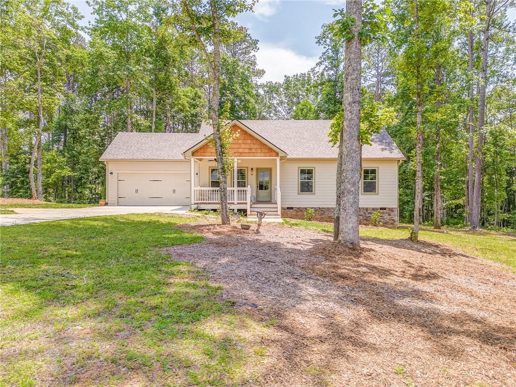 Welcome to The Hammock in Ellijay a peaceful mountain style subdivision just a little over an hour north of Atlanta offering country comfort and convenience to Ellijay and Jasper! This beautiful home has the single level ranch layout ideal for families and anyone who prefers one story living. Open concept floor plan and cathedral ceiling in the living room creates spacious area for entertaining. Sip coffee from the front porch and watch the deer in this easy paced development. Super close to hiking, tubing, wineries, and apple orchards. Come look see fall in love! Move in ready just unpack and start living.