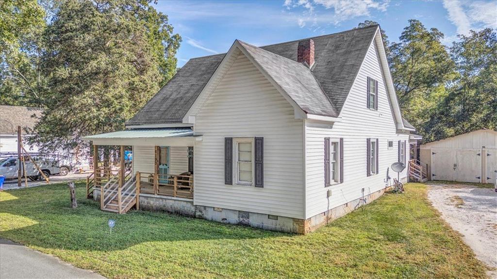 Charming, restored 1916 farmhouse in the heart of historic Covington! This 4 bedroom, 2 bathroom home offers over 2200?sq?ft of updated living space with original hardwoods, high ceilings, decorative fireplaces, and a spacious owner's suite on the main level. The country-style kitchen features an oversized island, eat-in area, farmhouse kitchen sink, walk-in pantry/laundry, and connects to a brick-floor mudroom. Upstairs includes two large bedrooms, two bonus spaces, and an updated full bath. With a detached 2-car garage including storage, ample storage throughout the home, and classic Southern charm and original details throughout! Enjoy peaceful outdoor living on the covered front and back porches overlooking a fenced yard with stone fireplace, muscadine vines, pecan trees, and various fruit trees. Located in Covington’s golf cart district, just minutes from the Square (home of Vampire Diaries, Heat of the Night, Walking Dead, Dukes of Hazzards filming and more), Cinelease's Three Ring Studios, I-20, Rivian plant, local parks, and the 14.25 mile Cricket Frog Trail (Covington's "Beltline").