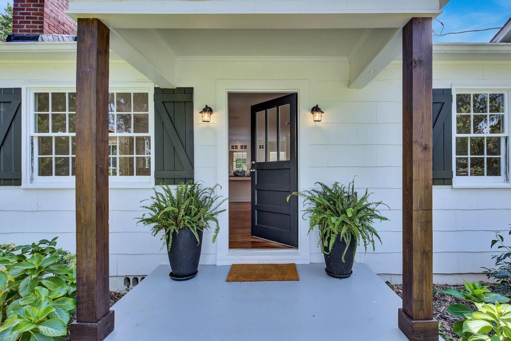 Storybook cottage updated to perfection! Welcome to 4141 Arrington Road - private and hidden from the road by mature trees and surrounded by a picket fence, you will step back in time as you walk up the stepping stones taking in the lush landscaping, cedar overhangs on the windows and new barn style shutters. The covered porch is inviting to your guests as you step through the front door into the main living area with a wall of built-ins and the open kitchen that is perfect for entertaining! Al fresco dining will be a snap with French doors that lead directly from the kitchen to your huge back deck! Large center island, beautiful farmhouse style cabinet doors and glass front cabinets combined with fresh white subway tile will make this a kitchen you will want everyone to see! Adjoining side room has french doors to the large back deck area, vaulted ceiling with Tiffany style lighting and beautiful shiplap detail makes a perfect office, breakfast room, or small den - the perfect spot to enjoy a sunny day! Located behind the kitchen area is a beautiful sunroom with abundant windows, shiplap detail, light wood LVP and access to the backyard. The laundry room is a place that you will want an excuse to do laundry! Large and airy with a wall of built-ins and more glass front cabinets - this room has a view into the kitchen and a wall of windows that allows the sun to come in from all directions. Each secondary bedroom has some kind of delight! Barn closet doors, glass front doors, built-in dressers, and restored antique hardwoods - it will be hard to chose! Primary bath has been renovated but still has kept the authentic feel of its 1947 roots - stained glass window, basketweave floor tile nods to days gone by but the huge frameless glass shower, and modern vanity fully feels modern and on trend. Large primary suite also has restored antique hardwoods and ship lapped wall. Large lot has plenty of potential for vegetable or flower gardens, room for a pool, fire pit - the possibilities are endless - In addition there is a large separate outbuilding that can be additional living space, garage, workshop, or art studio. There is truly NOTHING LIKE THIS HOME IN THE AREA! ONE-OF-A-KIND in every way!!*** SELLER WILL BE REVIEWING OFFERS SUNDAY AFTERNOON - PLEASE SUBMIT BY SUNDAY MORNING BEFORE NOON