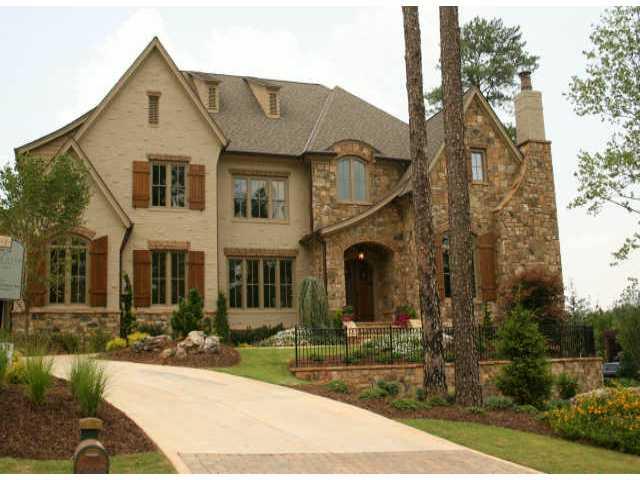 Brick lentels accent this five bdrm. 5 1/2 bath stone and brick home. Inside decorative ceilings and custom cabinetry add elegant touches to every day living. Host a party in one of this homes many entertaining spaces or enjoy quality time with loved ones in this home's more casual living areas.