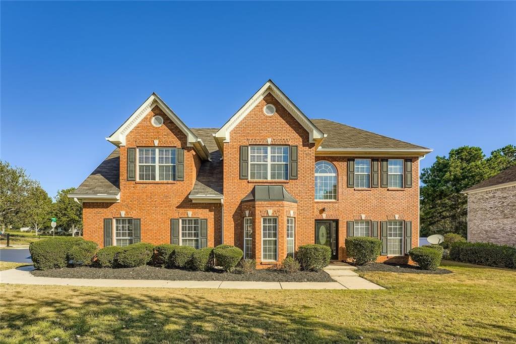 All brick, 5 bedroom beauty! Two-story Foyer opens to a formal living room on one side and bay window dining room with arches and upgraded trim on the other. Gourmet Kitchen opens to fireside family room and boasts solid surface granite countertops, tile backsplash, stainless steel appliances, custom cabinets, island with pendant lights, and breakfast coffee-bar. Powder room on main. Elegant Master suite showcases a cozy fireplace, sitting area, double trey ceilings PLUS a nursery/office/5th bedroom with French doors and closet (plus access to the hallway). Spa-like Master bath features separate his/her vanities, corner, jacuzzi tub, and double rain-showerheads. Hardwood flooring throughout. Spacious secondary bedrooms and double vanities in bathrooms. Large laundry room on main with washtub. 3-sides brick, corner lot, side entry garage with storage. Your backyard oasis awaits! Fully turfed, no grass to cut! Relax and enjoy your gorgeous completely tiled and covered outdoor terrace which features kitchen: sink, fireplace, ceiling fan, gazebo surrounded by private, white vinyl fencing. All new paint! Great location! Well established neighborhood with lake access. A true gem. Welcome Home!