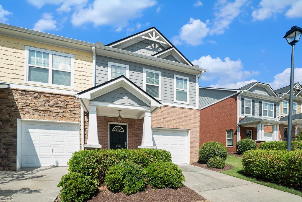 Turn-Key End-Unit Townhome in an Unbeatable Lawrenceville Location! Perfectly positioned near Sugarloaf Mills, The Mall of Georgia, Hwy 316, and I-85, this Move-In Ready Townhome offers exceptional convenience paired with comfortable, low-maintenance living. The Open Main Floorplan is ideal for both everyday living and entertaining, featuring a Light-Filled Family Room with a Cozy Fireplace and Sliding Glass Door that opens to a Private Patio Retreat. The adjacent Dining Room flows seamlessly into the Kitchen, complete with Oak Cabinets, a Stone Backsplash, Breakfast Bar, and ample counter space. A main level Half Bath adds everyday convenience. Upstairs, the Roommate-Style Floorplan offers privacy with two generously sized bedrooms each with its own Private Ensuite Bathroom and Walk-In Closet. The Primary Suite impresses with a Tray Ceiling, Dual Vanities, a Soaking Tub, and a Separate Shower. Enjoy resort-style living with Community Amenities including a Clubhouse, Pool, Playground, Dog Area, and Scenic Walking Trails. Don't miss your chance to own this end-unit gem in one of Lawrenceville's most convenient locations!