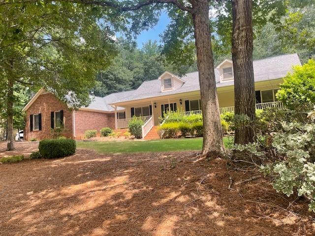 Beautifully updated 3BR/2.5BA brick ranch in the highly sought-after Lakehaven community with access to two swimming pools and tennis courts. This spacious single-level home features fresh interior paint throughout, new carpet, and luxury vinyl flooring in bathrooms, plus a welcoming front porch. The large living room offers a gas brick fireplace, recessed lighting, ceiling fan, and tray ceiling, and opens to a bright sunroom overlooking the private backyard. The freshly painted kitchen boasts ample cabinetry, a breakfast area with built-in china cabinet, and a separate formal dining room. The oversized master suite includes a tray ceiling, two walk-in closets, and a newly renovated master bathroom with granite double vanity, garden tub, and separate shower. Secondary bedrooms are generously sized with ample closets, and the full bath features an updated granite countertop. The laundry/mudroom provides cabinetry, a utility sink, and an additional half bath. A three-car garage offers abundant storage. Landscaped lot with mature trees. Convenient to shopping, dining, schools, and I-75. Move-in ready!