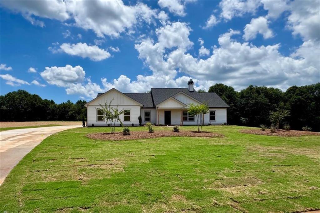 Introducing this Charming 3BR/2BA Ranch-Style Home on Over 1+ Acre with Luxurious Finishes and Peaceful Pasture Views. Welcome home to this beautifully crafted 3 bedroom, 2 bathroom ranch-style retreat set on a picturesque 1+ acre pasture lot. From the inviting covered front porch to the expansive covered back patio with stunning tongue and groove ceilings, every detail is designed for comfort and timeless appeal. Step inside to find luxury vinyl plank (LVP) flooring throughout-no carpet anywhere-an airy open-concept layout, and a cozy wood-burning stone-front fireplace that anchors the vaulted living space. The heart of the home is the chef-inspired kitchen, complete with a freestanding kitchen island, granite countertops, soft-close cabinetry, and contemporary finishes that exude style and functionality. A window over the kitchen sink offers views into your expansive backyard-perfect for warm summer nights and peaceful mornings. The owner's suite features a tray-ceiling, spa-worthy bath complete with huge double vanity, oversized tiled super shower for ultimate relaxation, & expansive walk-in closet. Every home includes a full builder-backed 1-year warranty and a 2-part orientation and walk-through process to ensure a smooth, confident transition into your new home. *As an added bonus, take advantage of special incentives when using our preferred lender-making your path to homeownership even more rewarding! This is more than just a home-it's where modern comfort meets classic countryside charm. Come live the Creekstone lifestyle today! Welcome to Creekstone - A Hidden Gem in the Heart of Hartwell, Georgia. Discover Creekstone, Hartwell's newest luxury lake-town community nestled off Jane Road, just minutes from the charm of downtown Hartwell and the scenic Reed Creek area of Lake Hartwell. Designed for those who crave the serenity of country living without sacrificing convenience, Creekstone offers a rare blend of rural elegance and modern accessibility. Set on expansive 1+ acre pasture lots, this picturesque enclave features beautifully crafted ranch and 1.5-story homes starting from the high $300Ks-each home thoughtfully positioned to maximize privacy, views, and connection to nature. Whether you're enjoying a quiet evening on the porch or launching your boat at one of the nearby Lake Hartwell public ramps, Creekstone invites you to savor every moment. Just minutes to downtown Hartwell's boutiques, restaurants, farmers markets, and live music. Close to Reed Creek, one of Lake Hartwell's most desirable recreational corridors. Quick access to shopping, dining, and everyday essentials without the hustle of city living. Zoned for highly rated North Hart Elementary School, a favorite among local families. Only a short drive to Hart State Park, boat launches, and walking trails. Easy commute with direct access to I-85, connecting you to Atlanta, Greenville, Athens, Clemson, and beyond. Creekstone is more than a neighborhood-it's a lifestyle rooted in natural beauty, community pride, and lake-town luxury. With some of the prettiest and most desirable lots in Northeast Georgia, Creekstone offers the rare chance to live surrounded by peaceful pastures while staying connected to all the best Hartwell has to offer. Come home to Creekstone-where the lake life, land, and luxury come together.