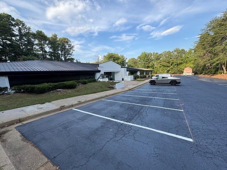 Located 5 minutes from Halcyon! Welcome to 5000 McGinnis Ferry, an impressive office building/warehouse situated on corner lot of McGinnis ferry and old Alpharetta rd. This is 21,000 sq ft building on almost 3 acres corner lot.  with ample space and unique details. This property includes spacious interior areas, allowing for flexible use and potential customization. Its outdoor space is expansive, providing opportunities for various outdoor activities or further redevelopment enhancement. The property is situated in a desirable windward business community with access to all amenities. Property is zoned industrial. The layout and structure emphasize both comfort and functionality, catering to a range of lifestyle needs. This property presents a distinctive and well-thought-redevelopment opportunity into shopping center or gas station.