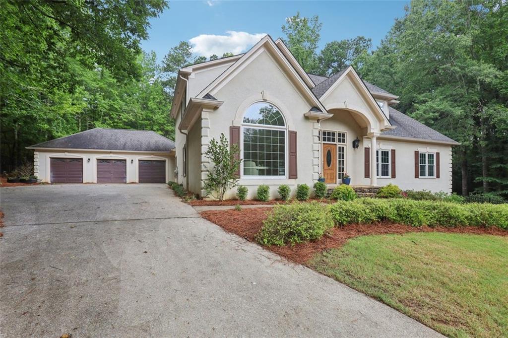 Tucked into the trees up on a hill, this dream home checks every box. This 5-bedroom, 4.5-bathroom retreat welcomes you with soaring ceilings, a grand entry, and an open-concept living area filled with natural light from arched windows that overlook the private backyard oasis. The primary suite is conveniently located on the main level, offering a peaceful escape with spa-like features.
Entertain with ease in the spacious family room, cook up memories in the well-appointed kitchen with breakfast nook, and take the party outside to the resort-style pool. The fully finished basement includes a second kitchen, washer/dryer, and private entrance—perfect for multigenerational living, guests, or income potential. Bonus features include a three-car garage, screen porch, and an outdoor kitchen space, ready for your grills of choice.
All of this is nestled in a sought-after West Cobb neighborhood with top-rated schools, nearby parks, and easy access to shopping and dining.