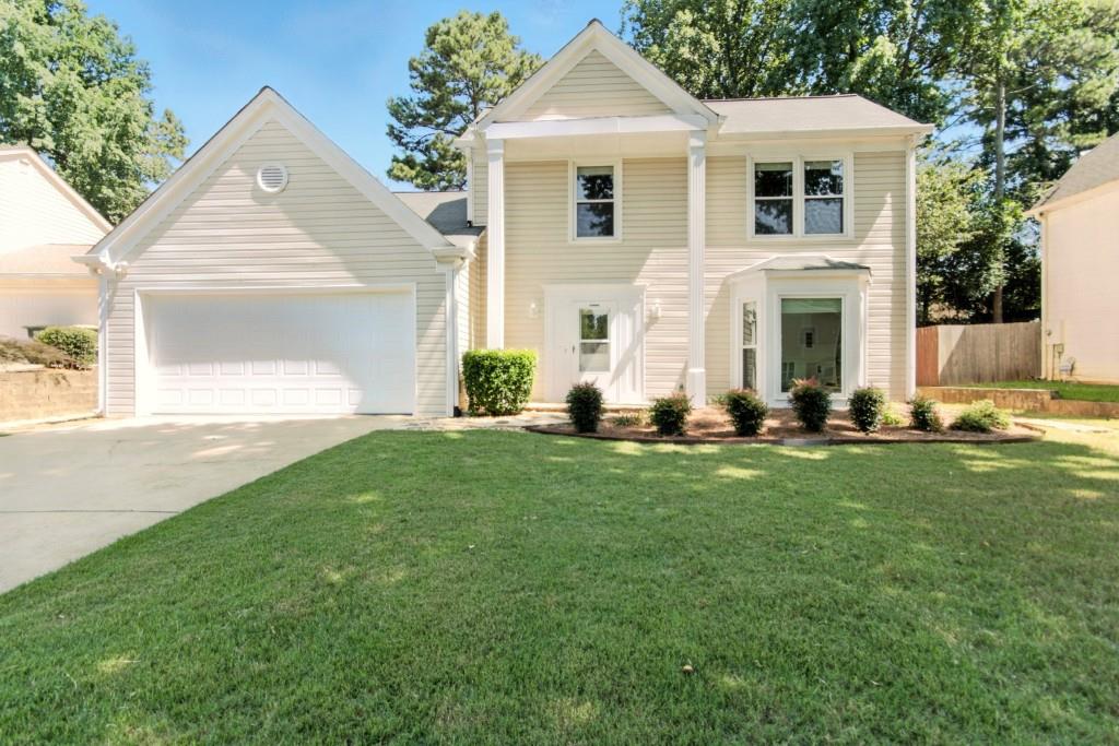 Beautifully refreshed and awaiting new owners! This gorgeous 2 story home features the primary bedroom on the main, a huge open family room with cozy fireplace & kitchen open to family room. The half bath on main is situated near the front door providing ease of access for you and your guests and the laudry room is tucke away near the garage area.Travel upstairs to two secondary bedrooms which share the hall bath.The upstairs gives you amazing views of the family room below and if that isn't enough to entice you, check out the covered back patio which is designed for outdoor living overlooking the backyard.This home features a 2 car garage & additional parking in the driveway but the best part is NO HOA.Minutes from Avalon,North Point Mall and GA-400.Come see what this charming location has to offer you and your family.This home has been virtually staged to enhance its potential.