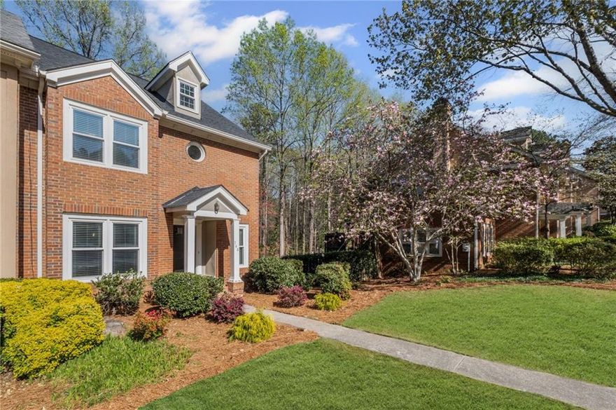 Welcome to this STUNNING & FULLY REMODELED townhome located just steps from Olde Towne Athletic Club. You are going absolutely love the LOW MAINTENANCE luxury vinyl plank flooring throughout the entire home (NO CARPET) and the light and bright floorplan. Cooking is a breeze in the chef's kitchen complete with stainless appliances and beautiful quartz counters. The fireside living room is located on the back of the home, is extremely spacious and overlooks the wooded natural area (perfect for wildlife watching). Upstairs you will find a perfect roommate floorplan with a primary suite that features his/her closets and a REMODELED BATH + second guest room with en suite bath. Laundry is also conveniently located on the upper floor. The terrace level is home to a 2 CAR GARAGE and a small finished area that would be perfect for storage or a home office. NEW WINDOWS, NEW ROOF, NEW WATER HEATER, and EVERY SURFACE REMODELED = MOVE IN READY for you! Located in the coveted Walton school district and just a few minutes to GA400 and I-285, this place is A PERFECT 10 and you are absolutely going to love it here. WELCOME HOME!