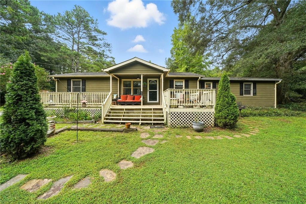 MOTIVATED SELLER! Discover the best of both worlds with this charming 3-bedroom, 2-bath ranch on a full acre in the heart of Woodstock. Tucked away on a private gravel drive, this home offers a peaceful, private retreat while keeping you close to all the shopping, dining, and energy of downtown.
Step inside to find a spacious layout designed for both comfort and convenience. The living room features a cozy wood-burning fireplace, complemented by luxury vinyl flooring. The large kitchen makes cooking and entertaining a breeze, while a separate dining room and office area give you flexibility for everyday living. Beautiful barn doors, a dedicated computer nook, and thoughtful touches throughout add both style and function.
The primary suite includes a walk-in closet and a spa-like bath with a wheelchair-accessible tub/shower combo featuring jacuzzi jets and aromatherapy. Wide, open spaces throughout the home make it welcoming and easy to navigate.
Outside, the level yard provides ample space for gatherings, gardening, or simply enjoying the privacy of your land. A pole barn and outbuilding/workshop give you endless options for storage, hobbies, or projects. With plenty of parking, wheelchair accessibility, and a location that feels private yet central, this property is a rare find in bustling Woodstock.