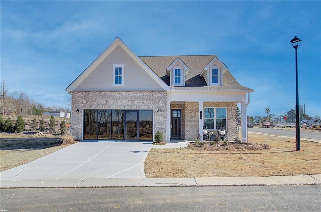 Welcome to Traton Homes Courtyards at Traditions, and our most popular Newman floorplan. This homesite is the MODEL HOME and will be READY TO MOVE IN DECEMBER 30 and located in Cumming, Ga. 1 mile from 400. This beautiful homesite is a Ranch home with 3 bedrooms and 3 full baths with an office and media room. It has an open floor plan that truly embodies a casual yet elegant lifestyle. The well-appointed living spaces includes a gourmet kitchen w/a spacious walk-in pantry, large kitchen island, dining area and family room w/42" fireplace and a very large storage room near the family/dining area. The luxurious owner's suite features an elegant bathroom with double-vanity, tiled zero entry shower w/bench and shelf and walk-in owner's closet. The family room offers views of the LARGE screened in porch that overlooks the preservation area of large trees and privacy, perfect for relaxing or entertaining. The split bedroom plan offers a guest suite with an en-suite bath and walk-in closet. The laundry room connects to the owner's closet. This price also includes shutters throughout the home. The builder is offering this homesite at the special price of $749,900 if the buyer pays CASH or uses one of our Preferred Lenders. The Preferred Lenders are also offering up to $10,000 until 10/30/25. All applicants must prequalify with our lender regardless of who they chose for their loan. All incentives are tied to prefer lender only. You MUST ALSO SEE this Model in this community. BEAUTIFUL HOME in one of the BEST LOCATIONS in the Metro Atlanta area!! Close to shopping at The Collection at Forsyth, Avalon and Halcyon. 1 mile to grocery store, shopping and the Greenway will connect to this community. READY TO MOVE IN !