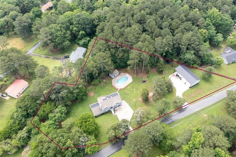 No HOA – Just Freedom, Space & Style!
Welcome to your dream retreat on 1.92 acres of peaceful country living—with no HOA restrictions! This beautifully updated home offers modern comfort, flexible living, and endless possibilities for work, play, or multi-generational living.
Inside, you’ll find two stunning kitchens, both fully renovated with shaker-style cabinets, soft-close drawers, and stainless steel appliances. The main kitchen also features a reverse osmosis system for pure, clean water. Updates throughout include new flooring, baths, and mechanicals—all within the last 5 years!
Multi-Generational Living Made Easy-
This home features TWO luxurious primary suites, ideal for in-laws, teens, or guests. The lower level offers a private entrance, full kitchen, suite, flex room, and two additional full baths—a true in-law or teen suite that lives like a second home!
A Workshop Like No Other-
Calling all car lovers, woodworkers, hobbyists and entrepreneurs—this 1,600 sq ft detached workshop is a rare find. Built with 4000 psi commercial-grade concrete (8” footers, 6” slab), it features:
Three 14x14 insulated bay doors|16’+ insulated walls|Wood-burning stove|Private driveway access|12’ covered patio—perfect for relaxing after a day’s work
Whether you're building cars, or just need serious space for all of your "toys", this shop is a game-changer!
Outdoor Living + Energy Efficiency-
Relax on the spacious deck overlooking your 18x36 splash pool (with new liner) and pool cabana ready for your finishing touches. Solar panels and a Generac backup battery slash utility bills and offer peace of mind during outages.
Minutes from I-75, downtown Cartersville, Tellus Museum, Savoy Auto Museum, and the upcoming Rome-Cartersville Development Corridor, this home offers country privacy with city convenience.
Come see it in person—this one truly has it all!
