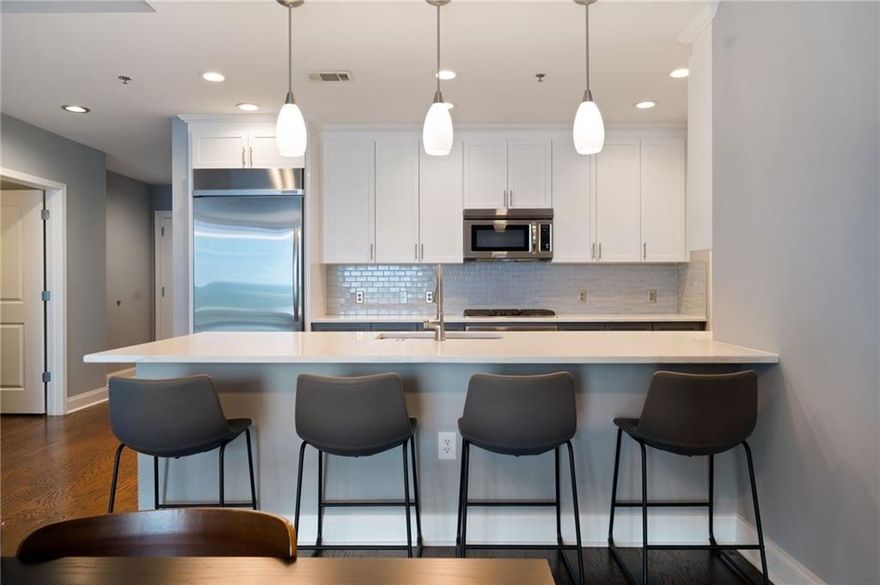 Soaring above the city skyline, this sophisticated residence at The Atlantic pairs dramatic floor-to-ceiling glass with timeless wide-plank hardwoods for a truly elevated living experience. This 2-bedroom, 2.5-bath home showcases sweeping city views and a spacious, light-filled layout ideal for refined urban living. The chef’s kitchen features stainless steel appliances, gas cooking, and sleek finishes, while the sun-drenched primary bath offers double vanities, a separate soaking tub, a frameless glass shower, and abundant natural light. Enjoy seamless indoor-outdoor flow with generous balcony space perfect for entertaining or relaxing. Residents benefit from 24-hour concierge and security, a resort-style pool, state-of-the-art fitness center, and an elegantly designed club room—all in the vibrant heart of Atlantic Station.