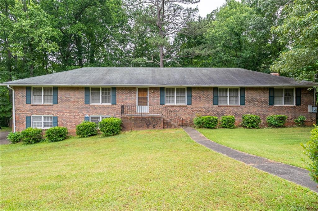 Are you searching for a home with ample space to grow, all on one level? Look no further! This charming, raised ranch with four-sided brick is located on a peaceful street and has been meticulously maintained. It boasts 3 bedrooms and 2.5 bathrooms, a spacious kitchen with extra storage, and a cozy living room with lots of natural light. The additional family room is spacious with tons of character and a beautiful fireplace. The back deck overlooks a private backyard, perfect for relaxing or entertaining guests. The partially finished basement is stubbed for electricity and water, offering the potential for 2 additional bedrooms. It also features plenty of storage with built-in shelves, a workshop, and room to park multiple vehicles. Best of all, there are no rental restrictions and it's just a short drive to Marietta Square and Truist Park. Don't miss the opportunity to make this quiet neighborhood your new home!