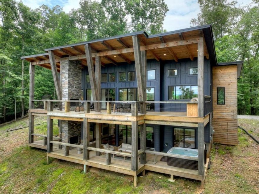 Welcome to 897 Faraday Drive - a striking contemporary chalet nestled in the heart of the sought-after Coosawattee River Resort. Blending modern mountain design with the warmth of rustic elegance, this stunning retreat features two expansive levels of open-concept living framed by soaring walls of glass that flood the home with natural light and frame year-round layered mountain views. Perfectly positioned on a serene lot within this gated resort community, the residence offers three private bedroom suites, including a luxurious primary with spa-inspired ensuite. The gourmet kitchen is a chef's dream, complete with premium appliances, sleek cabinetry, and an oversized island ideal for entertaining. The terrace level offers a spacious den, custom wet bar, and access to outdoor living spaces designed for relaxation and gatherings. Enjoy the unmatched lifestyle amenities of Coosawattee River Resort - including river access, multiple community pools, pickleball courts, fitness center, and a beautifully appointed clubhouse. Whether you're looking for a full-time residence, a high-end mountain getaway, or a luxury short-term rental opportunity, 897 Faraday Drive is your modern escape to the North Georgia mountains.