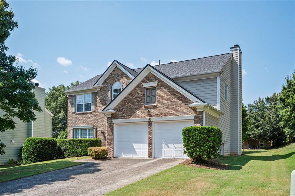 Welcome to this charming two-story brick-front home located on a spacious lot at the end of a quiet cul-de-sac in the desirable Chastain Glen community. Step into a dramatic two-story foyer that leads into a bright and open floor plan. The cozy family room features a gas fireplace and opens to the eat-in kitchen with a center island, white cabinets, newer stainless steel appliance including a new dishwasher and a stylish new floor. The kitchen also includes a new faucet, adding modern touches to this inviting space. The main level offers a separate dining room that flows into a formal living room—perfect for entertaining or flexible use. Upstairs, all bedrooms are thoughtfully placed, including a spacious primary suite with a large walk-in closet and en-suite bath featuring a double vanity, garden tub, and separate shower. The upstairs laundry room with washer and dryer adds convenience, and new toilets have been recently installed. Enjoy peace of mind with a roof replaced in September 2020.Chastain Glen is a well-maintained community with swim, tennis, and playground amenities, and no rental restrictions—ideal for homeowners and investors alike. Conveniently located near I-75 and I-575, Kennesaw State University, dining, and shopping.