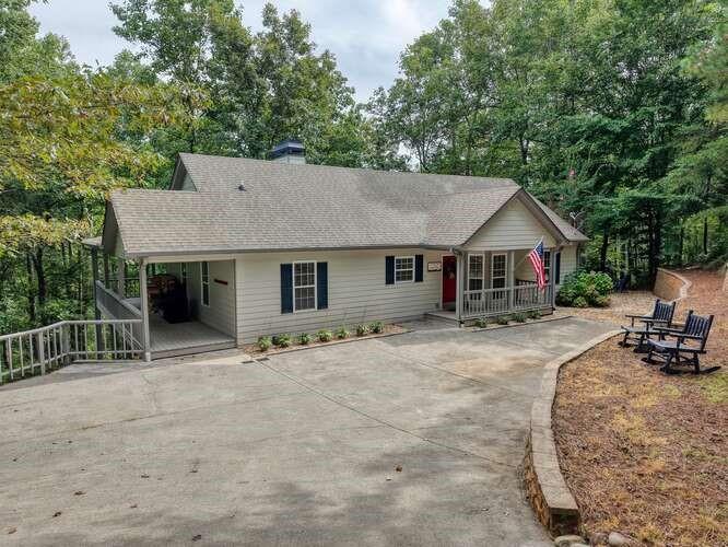 Charming Ranch Home with Creek Frontage and Seasonal Mountain Views!!! Nestled in a serene mountain cleft, this beautiful ranch-style home offers the perfect blend of privacy, natural beauty, and comfort. Enjoy seasonal mountain views and the peaceful sounds of a babbling creek that borders the property. The flat bottomland by the creek is ideal for fishing, family gatherings, cookouts, and creating lifelong memories in the great outdoors. Step inside to find a spacious owner’s suite that opens directly to a covered porch—complete with a relaxing hammock to soak in the peace and quiet of the North Georgia Mountains. The open kitchen features a breakfast bar and connects seamlessly to the dining area and family room, which boasts double French doors leading to a covered deck overlooking Bell Creek. The main level also includes two additional bedrooms and a generously sized bathroom. Downstairs, a fully finished basement offers two more large bedrooms, a spacious family room, and plenty of room for a game area or home theater and a full finished bathroom with two large storage areas. Step outside to the covered patio where you’ll find a hot tub and outdoor shower—perfect for relaxing after a day in the mountains. Additional features include: Fire pit area for cozy nights under the stars Wrap-around double-deck porches for extended outdoor living Paved road and driveway access Located in the highly desirable Bell Creek area Close to downtown Hiawassee, Lake Chatuge, Hayesville, and Murphy, NC, Ga Mountain Fairgrounds, PickleBall Courts and public beach area. Don’t miss this opportunity to own your own piece of mountain paradise. Schedule your showing today!