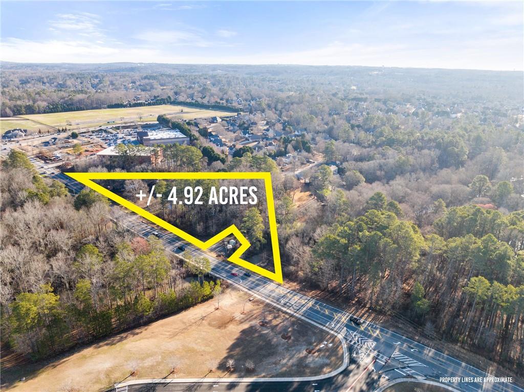 Vickery Village! Located next to OneLife Fitness and across from Vickery Creek Middle School. This listing is for an assemblage of 4 parcels- Currently zoned AG and was rezoned to Commercial, but has the possibilities to rezone if needed. The Polo Fiends backs up to this assemblage of almost 5 +/- acres. You can't beat the road frontage on Post Rd! Down the street from shopping, restaurants, live music, parks, hiking, and so much more. Great land opportunity!