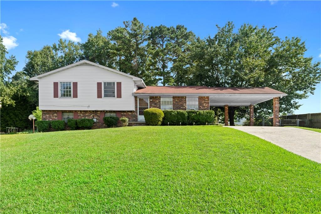 Come see this 4-bedroom, 2-bath split-level home in Riverdale, conveniently located near Interstate 75. The main level offers a spacious open floor plan with a living room, dining area, and kitchen. Upstairs, you'll find the master suite along with two additional bedrooms and another full bathroom. The lower level includes a bonus room that could be used as a bedroom, plus storage space and a laundry room. Other highlights include a fenced backyard, rear patio, and a 2-car carport.