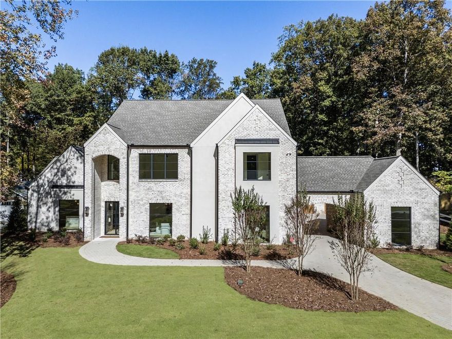 Just completed (11/1/25) Luxury new construction in Downtown Alpharetta’s Garden District!
Premier opportunity on one of the most spectacular, level lots in the highly sought-after Garden District of Downtown Alpharetta. This expertly designed, entertainer-focused home is thoughtfully laid out and built with craftsmanship in every detail.  This all-brick home with stucco accents showcases soaring 12'+ ceilings in the Great Room, Kitchen, and Keeping Room—creating dramatic volume and natural light throughout the heart of the home. Exceptional features include: 4-car garage + porte-cochère parking, Custom heated saltwater pool & spa with dedicated pool bath. The 12 ft vaulted outdoor screened in lanai is an extension of living space with an outdoor kitchen. Exquisit finishes include all Aluminum 8–10' casement and fixed windows/doors, Extra wide 10 1/4” designer hardwood flooring throughout, Double-sided floor-to-ceiling ledger stone fireplace blending great room and kitchen with warmth and openness.  The chef's kitchen is the true showstopper offering Extensive custom beaded inset cabinetry, Wolf/Sub-Zero appliances, Massive hidden pantry & separate scullery with extra appliances—ideal for entertaining or catering. Dramatic ceiling detailing that adds texture and elegance to the space. The butler pantry is stained wood cabinetry offering a sink, ice maker and beverage fridge for endless gatherings with friends and family. The main-level primary suite is a serene retreat with a luxurious spa bath featuring a wall-to-wall windowed shower offering Kohler fixtures, Dual furniture-style vanities, large format tile, and a generously sized custom closet designed with both form and function.  Also on the main level is a flexible second bedroom or office with a full bath, a stylish powder room, and a laundry/mudroom offering thoughtful utility space. Upstairs, you'll find four spacious en-suite bedrooms, each with walk-in closets, designer tilework, Kohler plumbing fixtures, and the flexibility to repurpose one or more as a home gym, office, or bonus/media room. This home offers it all: Premier access to Downtown Alpharetta's dining, shopping, festivals, and farmer’s market. A rare flat level backyard oasis with poolside entertaining in mind. High-end design and quality construction. Don't miss this rare chance to own a truly custom estate in Alpharetta’s most desirable in-town location. This home is ready just in time for the Holidays!