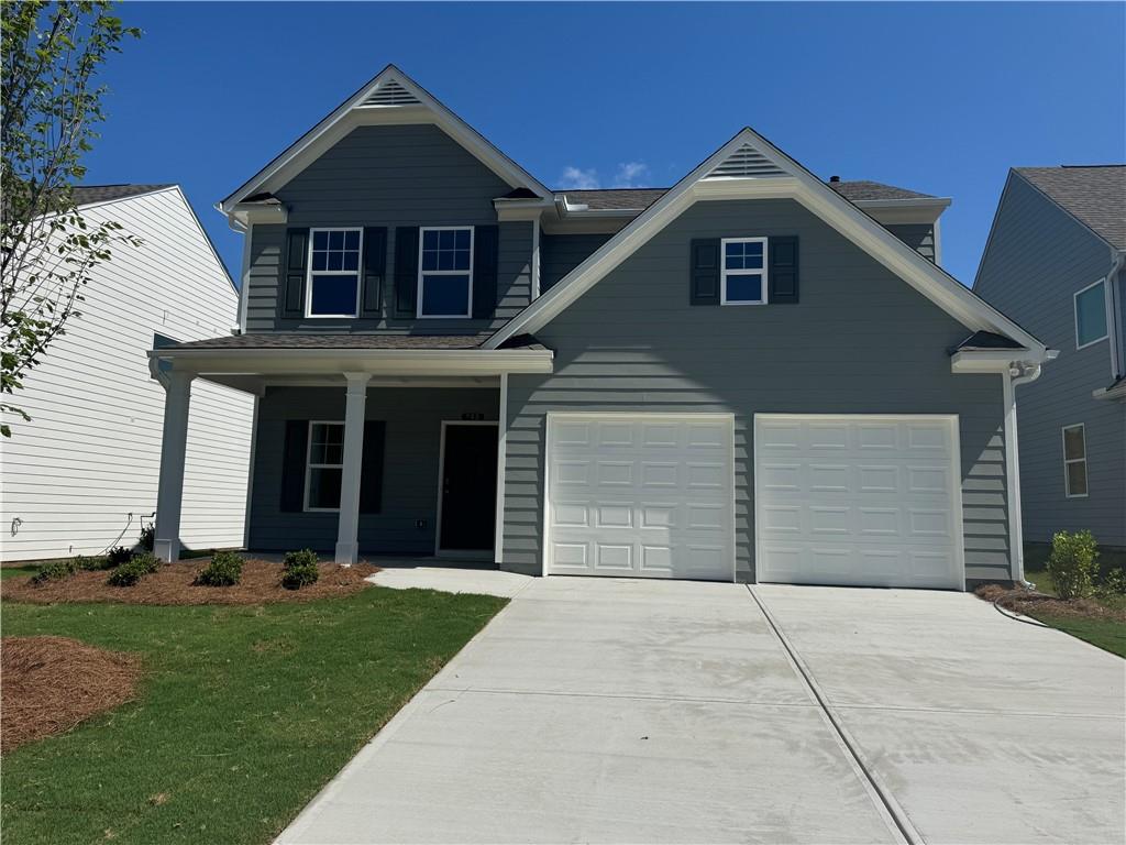 Two-story residence featuring a blue-gray siding exterior, white trim, and dark shutters