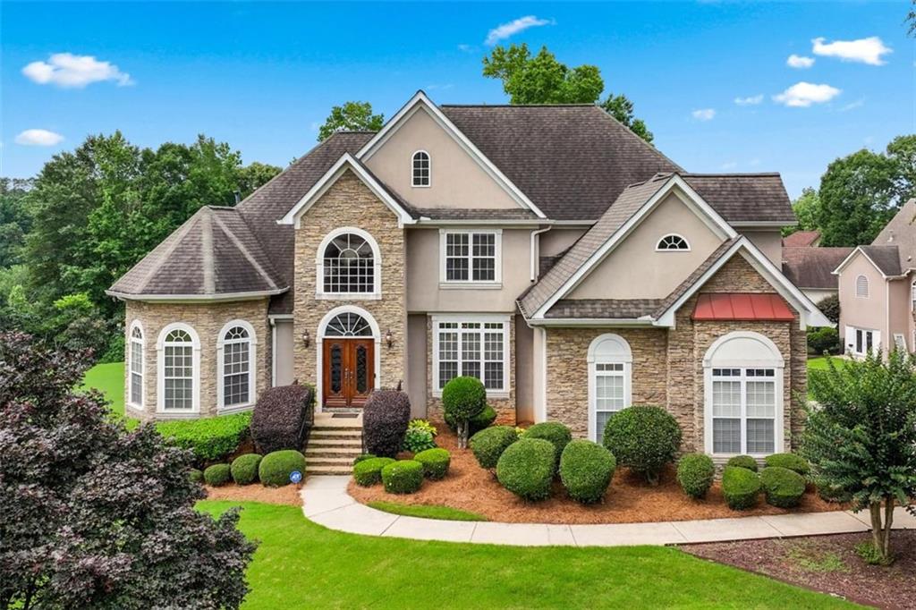 Welcome to this stunning 5-bedroom, 3.5-bath home where timeless elegance meets traditional charm-perfectly situated in one of McDonough's most sought-after communities. Step into the grand two-story foyer and you're immediately greeted by rich tiled flooring, which transitions seamlessly into beautiful hardwoods that flow throughout the main living areas. The main level offers a formal living and dining room, setting the tone for gracious entertaining. Just past the foyer, the spacious two-story family room invites you in with large windows that flood the space with natural light and a cozy fireplace that adds the perfect touch of warmth and comfort. The recently refreshed kitchen is a standout with its farmhouse sink, custom island offering ample storage, upgraded lighting, and a functional layout designed for everyday living. Adjacent to the kitchen is an inviting keeping room with a second fireplace-ideal for unwinding with a cup of coffee or sharing quiet moments with loved ones. Step outside to the elevated Trex deck with integrated lighting, where you can enjoy serene views of the lake located just behind the property-an ideal spot for fishing, fresh air, and quality time with family. The oversized owner's suite is conveniently located on the main level and features a private sitting area. Upstairs, you'll find four generously sized secondary bedrooms, offering flexibility for guests, family, or a home office setup. The home also features a 6-year-old roof, offering peace of mind and added value for years to come. A full, unfinished basement provides endless potential-whether you envision a home gym, theater room, playroom, or additional living quarters. Located in a top-rated school district and just minutes from shopping and dining, this home checks every box for comfort, space, and long-term value.