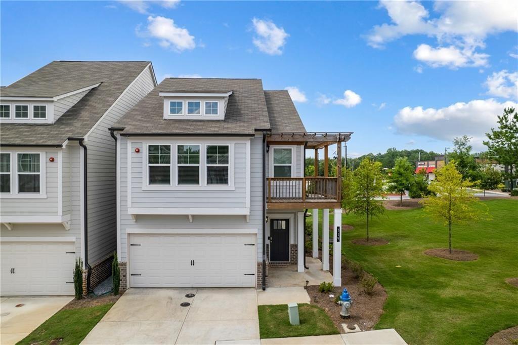 You're going to love this end-unit townhome! It’s super spacious and has the feel of a standalone home. This is the Athena floor plan, featuring 3 bedrooms, 2.5 bathrooms, and a 2-car garage—perfect for anyone looking for comfort and convenience. The kitchen is stunning, with white cabinetry and Niagara quartz countertops, while the bathrooms have sleek gray cabinets and white quartz, giving the home a modern, elegant touch. The primary suite is huge, complete with a luxurious en-suite bathroom and a massive walk-in closet. The main level features beautiful 5” RevWood hardwood floors, a fireplace with custom built-ins, solid oak stair treads, and iron baluster railings for that stylish, high-end look. And the best part? The primary suite opens onto a wraparound deck with a pergola, making it the perfect spot to enjoy your morning coffee or unwind in the evening. Living here means low-maintenance living, so you’ll have more time to do what you love. Plus, you’re just minutes from Historic Downtown Woodstock, with its charming local shops, amazing restaurants, and relaxing spas. If you're looking for a home with style and zero hassle, this is the one!