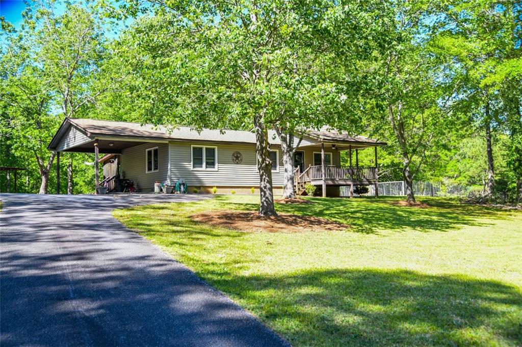 Ranch home on a private 5.36 acre track with a creek running along the back of the property. Two bedrooms, 2 baths, with an open kitchen and family room. Large screened in porch and covered front porch. Large workshop in the back. This is a great location, close to 365, wineries, Jaemor Farms, shopping, and more!