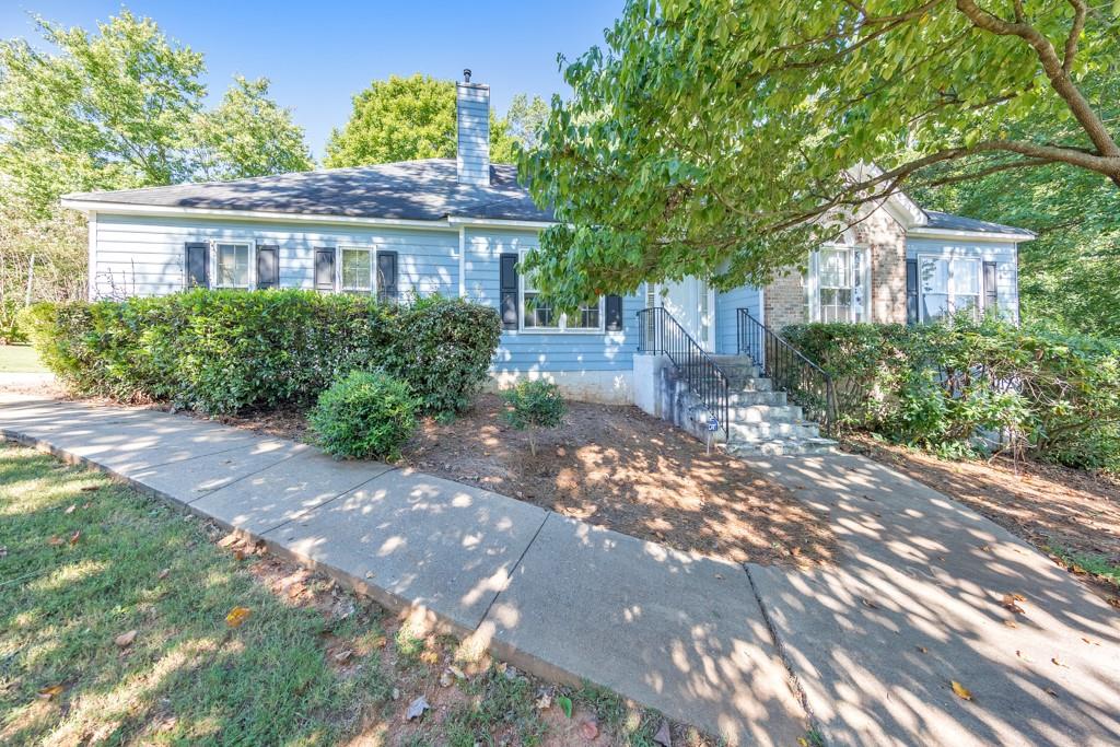 Welcome to this charming 3 bedroom / 2 bathroom ranch, perfectly situated on a spacious 0.344-acre corner lot in the desirable community of The Overlook! Step inside to find a warm fireside family room with soaring vaulted ceilings, ideal for both everyday living and entertaining. A separate dining room flows seamlessly into the kitchen, complete with white cabinets, a pantry, and a generous breakfast room. A convenient laundry room is located just off the kitchen. The inviting primary suite boasts tray ceilings, an ensuite bathroom with dual vanities, a relaxing whirlpool tub, a separate shower, and a walk-in closet. Two generously sized secondary bedrooms share a full hall bath. Enjoy outdoor living on the rear deck overlooking the private backyard. Additional features include an attached 2-car garage and access to community amenities such as a sparkling pool and tennis courts. All in a prime location with easy access to Marietta Square, Dobbins Air Force Base, and an abundance of shopping and dining options!