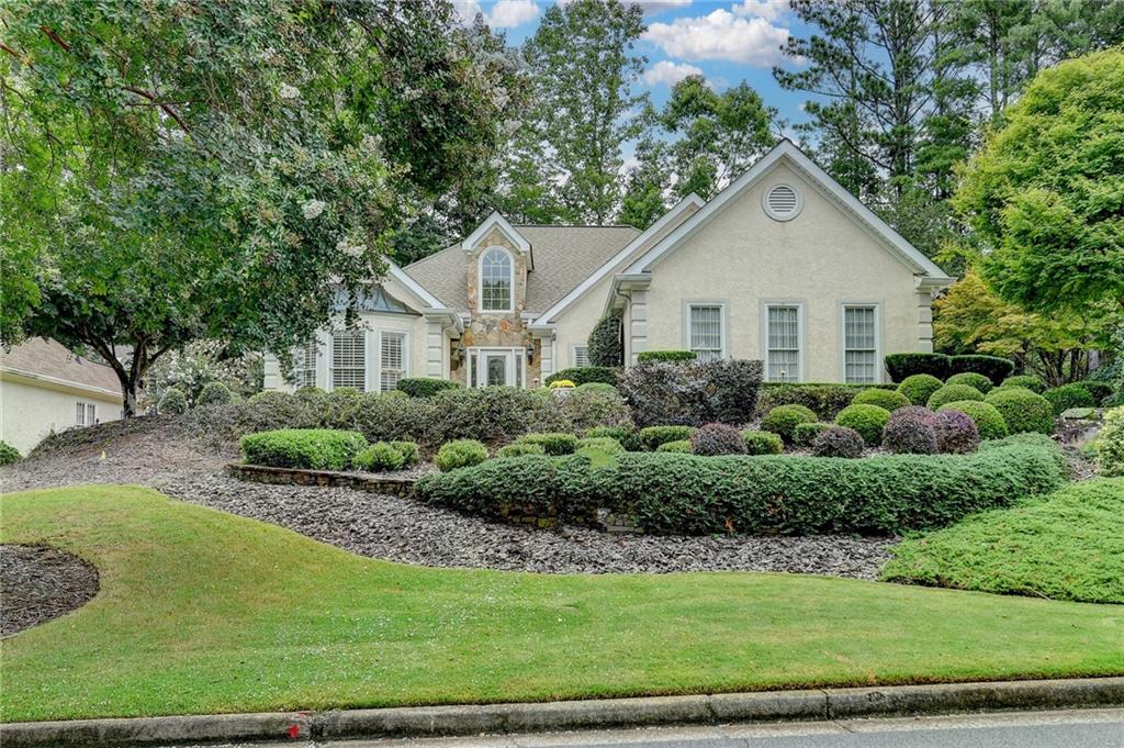 Come tour this beautifully maintained 3-bedroom, 2.5-bath hard-coat stucco ranch home located in the highly sought-after Medlock Bridge Subdivision. Just a short walk from both top-rated Johns Creek High School and Medlock Bridge Elementary, this home offers an ideal blend of comfort, convenience, and community living. The open floor plan features soaring vaulted ceilings that create a light and airy atmosphere throughout. The spacious primary suite is located on the main level and offers direct access to a charming private patio—perfect for enjoying your morning coffee or a quiet evening outdoors. THE PRIMARY BATHROOM HAS BEEN FULLY REMODELED with high-end tile and designer fixtures, offering a spa-like experience at home.
Two additional bedrooms are generously sized and thoughtfully connected by a Jack and Jill bathroom, ideal for family living or guests. The professionally landscaped yard surrounds the property, and the rear yard features a beautiful flagstone patio with ample privacy for outdoor entertaining or relaxing. The downstairs living room could easily be converted into a home office for those needing an additional space.
Residents of Medlock Bridge enjoy access to two full sets of community amenities, including two swimming pools, two clubhouses, 12 tennis courts, a basketball court, large soccer field, two playgrounds, a scenic fishing lake, and a peaceful nature trail. This is more than just a neighborhood—it’s a true lifestyle.
Located in the heart of Johns Creek, recently ranked the #1 Best Place to Live in the U.S. by U.S. News & World Report for 2025, this home is close to premier shopping, dining, and medical facilities, with easy access to major highways. It's also just minutes from Avalon and the soon-to-be-completed “Medley,” a 43-acre mixed-use destination featuring walking trails, boutique retail, restaurants with outdoor patios, community greenspaces, and year-round outdoor entertainment. This is an exceptional opportunity to live in one of metro Atlanta’s most vibrant and award-winning communities. Great location for St. Ives Country Club or Atlanta Athletic Club members too!
