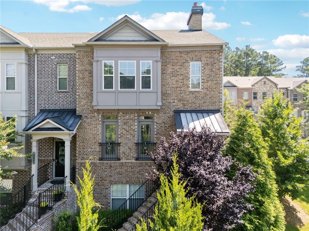 Welcome to this stunning end-unit townhome just one mile from vibrant Downtown Alpharetta! Nestled in a gated community, this 4-sided brick beauty offers the perfect blend of privacy, elegance, and convenience—with a brand new sidewalk currently under construction to directly connect you to the heart of the square. Inside, you'll find rich hardwood floors throughout, custom built-ins, and sun-drenched living spaces that radiate warmth and charm. The gourmet kitchen is a chef’s dream, featuring a double oven, walk-in pantry, and an open layout ideal for entertaining. Thoughtful design touches and abundant natural light make every room feel inviting. Enjoy community amenities including a cozy firepit area and a dedicated dog park, perfect for relaxing evenings or mingling with neighbors. Whether you're walking to local shops and restaurants or enjoying peaceful privacy at home, this townhome offers the best of both worlds.