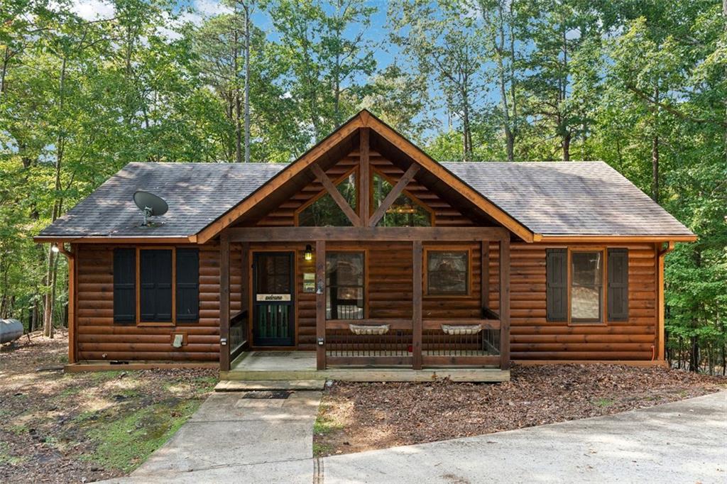 Welcome home to your cabin in the woods! Upon driving home, you are greeted by the circular driveway that leads to the charming covered front porch where you can sip on your coffee in the morning. Upon entering the home, the tall, vaulted ceilings and wood finishes remind you that you’ve made it to the mountain getaway you’ve been dreaming of. Features include 2 large bedrooms and 2 full bathrooms, as well as a den space that has its own fireplace. The open concept living area includes a second fireplace in the living room, as well as a well-appointed kitchen showcasing the rough sawn cabinetry and granite countertops. Head outside to spend time on the back deck, or explore the woods on the large 0.81 acre lot. The covered carport area sits next to the home, and has an additional enclosed storage area that can be used as a workshop as well. There is also a shed on the property, and a firepit area to sit around on cool Fall evening. All this while being located within the beautiful Coosawattee River Resort, which features pools, tennis courts, fish trap parks, hiking trails, tubing down the Coosawattee River, fishing and more! Come check it out today!