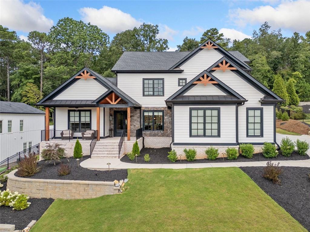 Luxury, privacy, and resort-style living await in this stunning 5-bedroom, 5.5-bath home in the exclusive Estates in Acworth. Positioned to take advantage of its peaceful surroundings, this home offers scenic vistas, exceptional privacy, and striking curb appeal.
Step inside to over 4,500 square feet of thoughtfully designed living space with 10 foot ceilings, including two true primary suites—one on each level. The main-level suite features a spa-like bathroom with a freestanding soaking tub, oversized double-entry shower, dual vanities, and an enormous walk-in closet. Upstairs, the second primary suite includes its own spacious walk-in shower and closet, ideal for multigenerational living or long-term guests.
From the moment you walk through the front door, you're greeted by a stunning open living area framed by a dramatic wall of sliding glass doors that offer a direct view of the outdoor kitchen and resort-style pool. These wide-opening doors blur the line between indoor comfort and outdoor entertaining, creating a seamless, light-filled space that feels like a private retreat.
This home was built for both everyday luxury and unforgettable entertaining. You’ll find multiple living areas, including a bright open-concept family room, a formal dining room, a great room off the foyer, an office/library, and a spacious upstairs loft. Every secondary bedroom includes a walk-in closet and private en-suite bath for maximum comfort and privacy.
The backyard is a showstopper—featuring a heated PebbleTec pool with integrated hot tub, built-in outdoor kitchen with granite countertops, grill, and ice maker, plus an electric retractable screen that transforms the patio into a screened-in lounge with the push of a button. Enjoy your own private retreat surrounded by a fully fenced yard, outdoor landscape lighting, and built-in speaker system for seamless indoor/outdoor sound.
Additional highlights include: 3-car side-entry garage with epoxy floors and custom storage cabinets, additional parking pad and expanded driveway, LVP flooring throughout the home, high-end lighting and fan fixtures, pre-wired whole-home and outdoor speaker system, whole-house water softener, filtration, and reverse osmosis system.
This one-of-a-kind property combines elegance, smart upgrades, and thoughtful design—all nestled in one of Acworth’s most desirable neighborhoods.
Schedule your private showing today!
