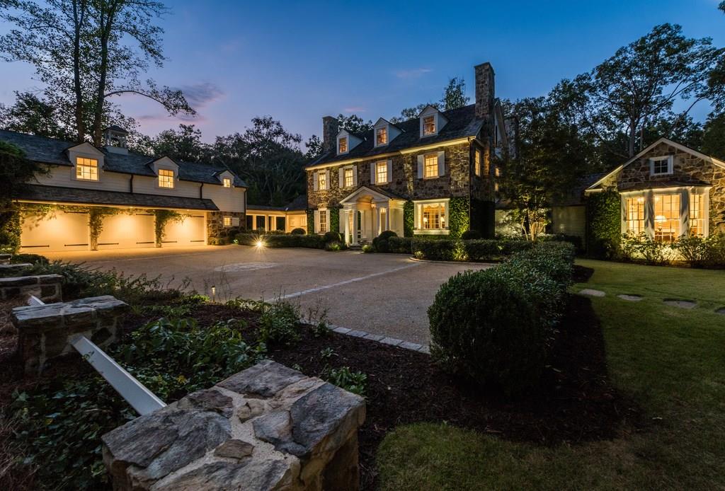 Designed by the nationally renowned talents of architect Stan Dixon and designer Jackye Lanham, this stunning stone estate was inspired by 18th-century Pennsylvania farmhouses. Approached by a private, winding & tree-lined drive, this stunning and immaculate home appears atop a hill overlooking nearly 2.3+/- acres of complete privacy in every direction. Beautifully appointed with 100-year-old reclaimed heart pine flooring and beams, 10.5-foot ceilings, extensive floor-to-ceiling woodwork and perfectly scaled rooms, the home possesses a simple elegance and unique warmth.