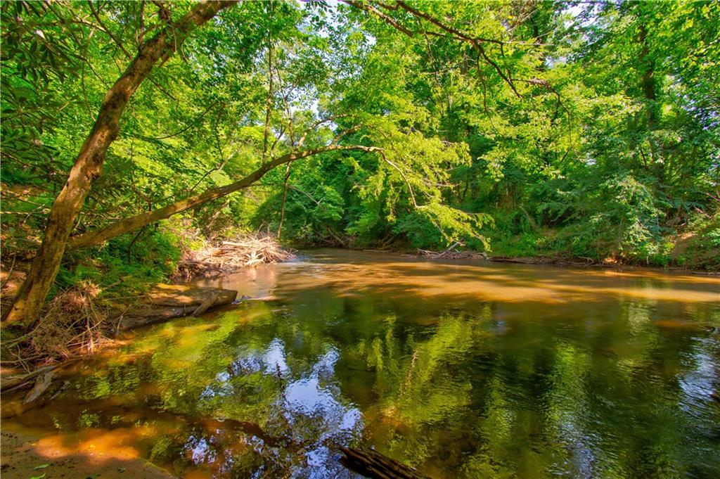 Welcome to the River! Unbelievable opportunity on the majestic Etowah. Never before on the market. Double sided river frontage and Mountain Views from the homesite! It doesn’t get better than this. End of the road privacy, useable level, river frontage. Beautiful homesite. See the river & hear the river! Enjoy the long range view, the blooming mountain laurels, rock outcroppings. This one has it all! Get in on one side of your property and float around to the other side. Grow & feed the trout and fish your very own honey hole. You won’t see this opportunity twice. Level 3 Soil Tests have been completed. Call today!
