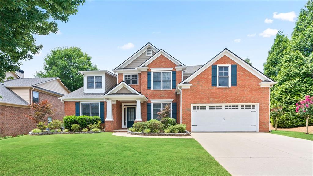 Light-filled spacious home with master on main in sought-after Buford HS district. This home features an open concept, enter through the two-story foyer into the grand two-story living room, leading to the chef's kitchen with stone counters. Large master on main with tray ceilings and bathroom with extra tall ceilings. Three more generous bedrooms and two baths upstairs. Spacious, level lot. Wonderful opportunity in growing Flowery Branch.