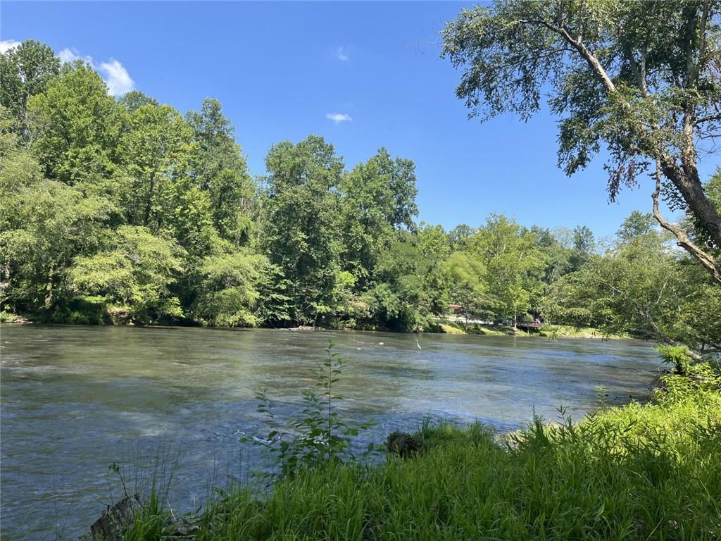 Now offering! Spacious wooded 0.74 acre sloped lot right on Beaver Lake Drive. Tucked within the desirable, amenity-rich Coosawattee River Resort, you'll enjoy stunning waterfront views, gated access, paved roads, pools, tennis courts, fitness facilities, hiking trails, river tubing and more. The serene setting provides unmatched privacy and a deep connection to nature—ideal for fishing, swimming, or simply unwinding. Located just minutes from charming Downtown Ellijay, you’re never far from dining, shopping, and entertainment. Short-term rentals are allowed, making this not only a peaceful escape but also a smart investment. Note: Access to the property requires a real estate agent for gated entry.