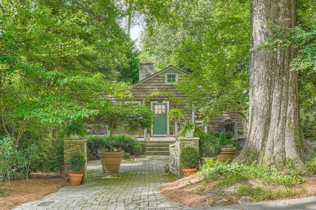 This most alluring and magical Buckhead cottage is a sanctuary in the heart of Atlanta. The serene energy absorbed soothes and calmly nurtures .The quiet, private setting on Virginia Place on a bluff above Peachtree Creek.(Seller notes that the property is not in the flood plain and that the property behind the rear property line belongs to a resident on Fairhaven Circle.) Driving up to the house, you will notice the front porch railing and the handsome bark shingles on the house front. The railing features rhododendron and the bark is poplar from Brevard, N. C. So you will feel the magic when you first see the home, complimented by well planned landscaping , reflecting privacy and peace. . Upon entering , the excitement and magnetic attraction impress you. The dining area, with wall of bookcases, and living area with fireplace, are centers of attraction. The adjacent kitchen, recently renovated, is a dream of taste, decor and convenience. Down the hall are 2 generous bedrooms; the 3rd could be used as an office study or den. The master bath ,recently renovated. is as you wish with style and comfort. Off the master is a most delightful screened porch , private ,relaxing and ripe for entertaining, just your "happy place"! From there you view or walk through
professionally and tastefully and dramatically planted garden areas. This is all so romantic and ready for parties. Do not miss this opportunity. You will never forgive yourself; regret is no friend !!!! This magnificent charm is lacking elsewhere , no where else in Buckhead. Follow your heart and you will ecstatic.