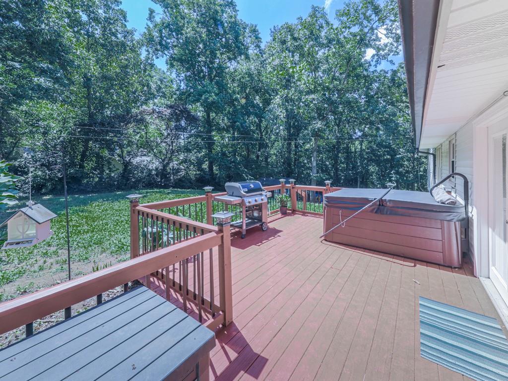 Charming Woodstock Home with In-Law Suite on Corner Lot in Little Brook Estates!
Welcome to 132 Little Brook Drive — a versatile and beautifully maintained 4-bedroom including in-law suite, 3-bathroom home nestled on a spacious corner lot in the desirable Little Brook Estates community. This thoughtfully designed residence offers comfort, functionality, and plenty of space for multi-generational living or guest accommodations. The main level features a desirable master suite on the main, along with two additional bedrooms and a full guest bath with a tub/shower combo and stylish ceramic tile flooring. The spacious eat-in kitchen with new stainless appliances opens to a cozy family room with fireplace, and French doors lead out to a wooden back deck complete with a grilling area and hot tub, all overlooking a peaceful, fenced backyard—perfect for relaxing or entertaining. Convenient stackable washer and dryer are located in the main level guest bath. Downstairs, enjoy a private in-law suite/studio with interior access, complete with its own kitchen, full bath with shower, full-size washer and dryer, and dedicated sleeping and seating areas. The suite also features a separate exterior entrance and driveway, ideal for added privacy or potential rental income. Outside, the very spacious fenced backyard includes a large workshop/storage shed and room for RV parking. Recent updates, along with new appliances, include new HVAC (June), newer roof with new gutters and gutter guards, and newer hot water heater—providing peace of mind for years to come. Located just minutes from Dowtown Woodstock, shopping, dining, and easy access to I-575 & Express Lane, this home truly offers the perfect blend of comfort, flexibility, and location!